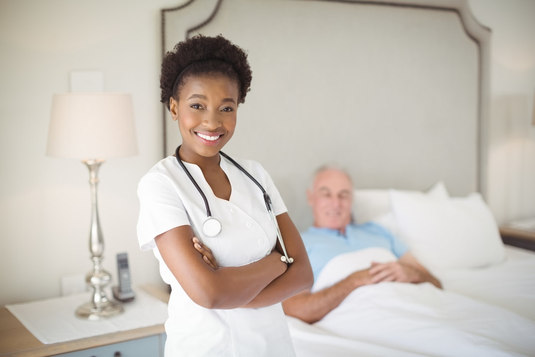 nurse standing beside the bed